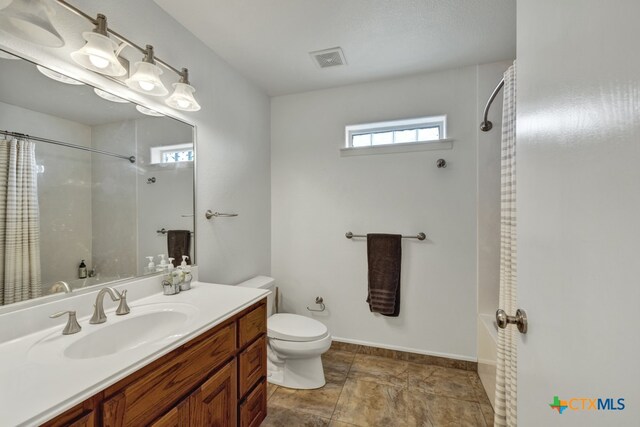 bathroom featuring vanity, toilet, and a shower with curtain