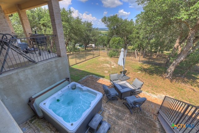 view of patio / terrace with a hot tub