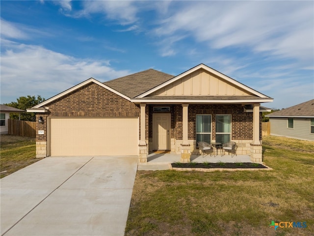 craftsman inspired home with board and batten siding, concrete driveway, brick siding, and a garage