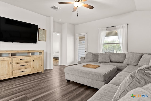 living area featuring dark wood finished floors, visible vents, vaulted ceiling, ceiling fan, and baseboards