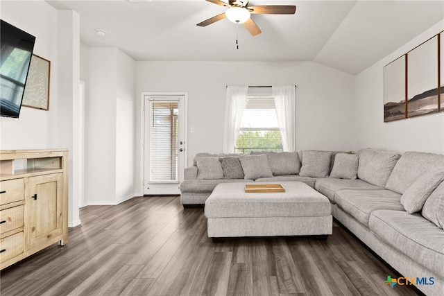 living area with lofted ceiling, baseboards, a ceiling fan, and dark wood-type flooring