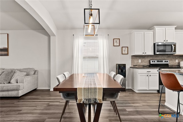 dining room with baseboards and dark wood finished floors