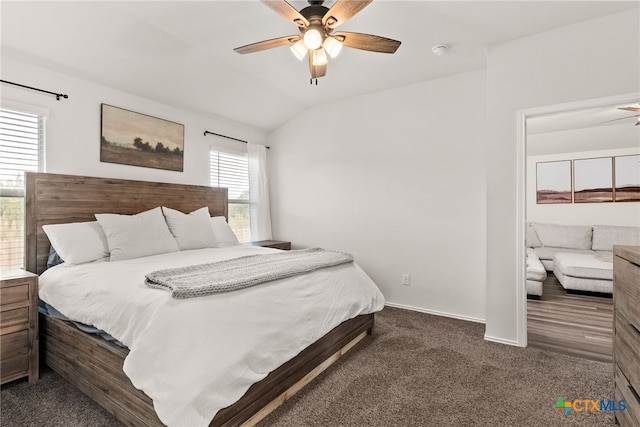 carpeted bedroom featuring vaulted ceiling, baseboards, and ceiling fan