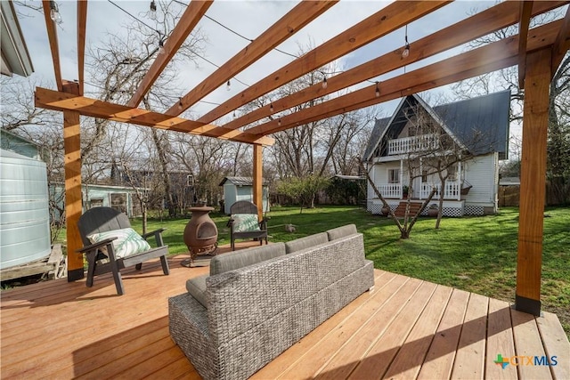 wooden deck with fence, a yard, a pergola, an outdoor structure, and a storage shed