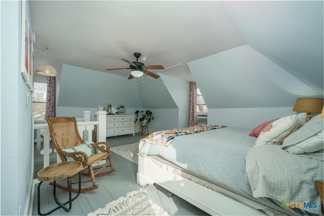 bedroom with vaulted ceiling, wood finished floors, and ceiling fan