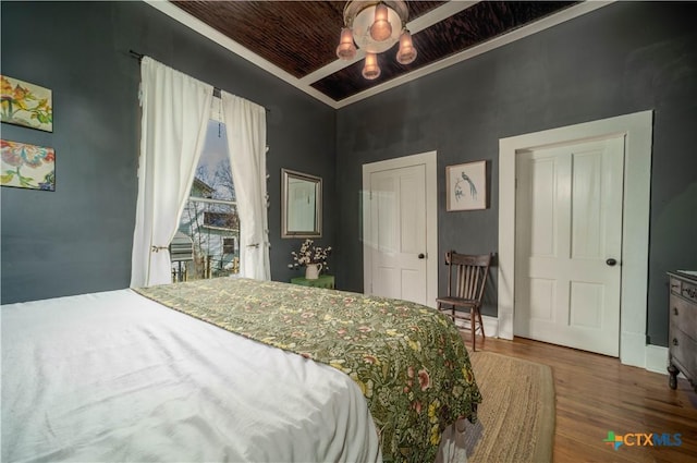 bedroom with wood ceiling and wood finished floors