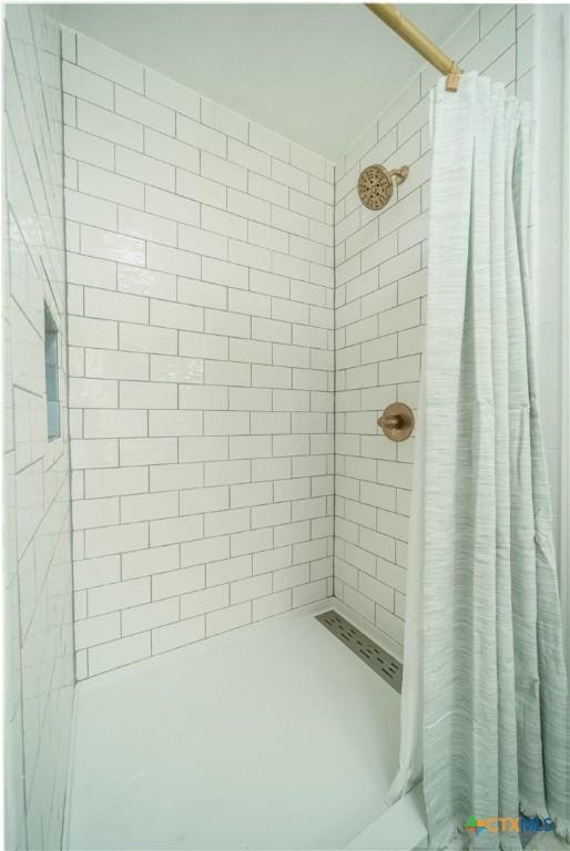 bathroom with a tile shower