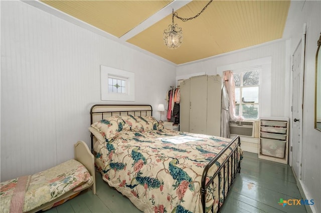 bedroom featuring cooling unit, hardwood / wood-style floors, and a chandelier