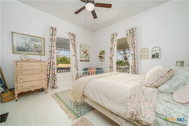 bedroom with a ceiling fan and wood finished floors