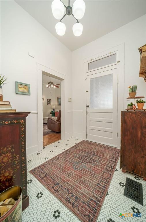 entryway with an inviting chandelier