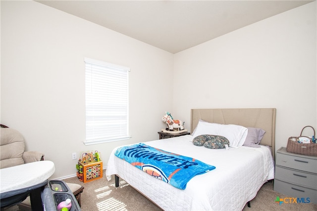 carpeted bedroom featuring multiple windows