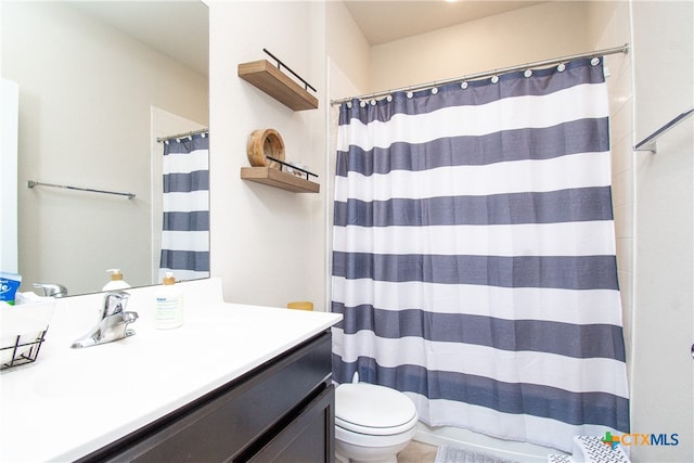 bathroom featuring vanity, toilet, and a shower with curtain