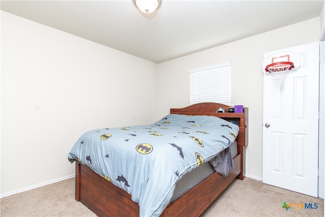 bedroom featuring light carpet