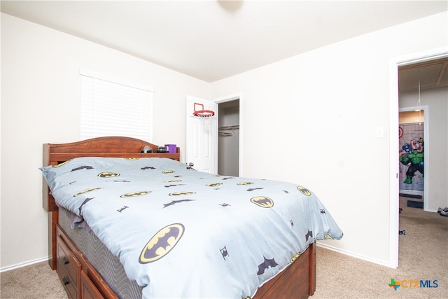 bedroom with light carpet and a closet