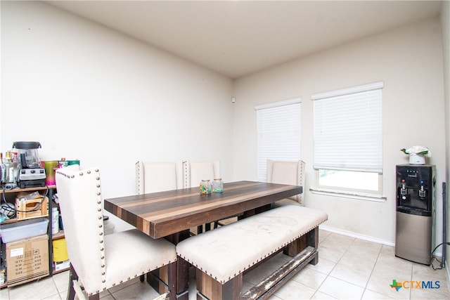 dining space featuring light tile patterned flooring