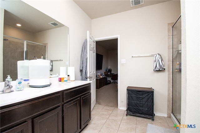 bathroom with walk in shower, tile patterned flooring, and vanity