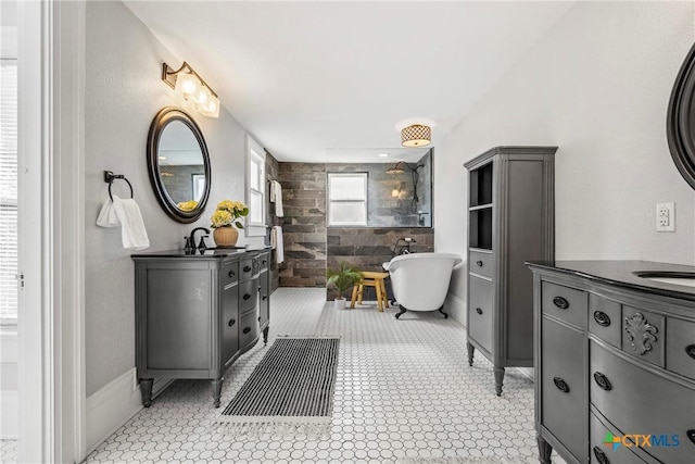 610 N 7th St, Temple, TX 76501 - full bathroom with two vanities, a soaking tub, and a tile shower
