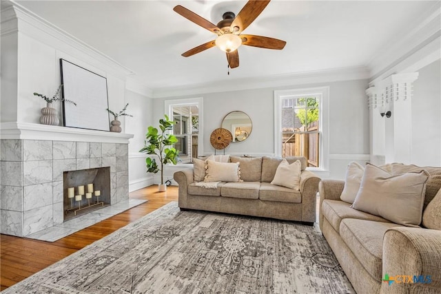 610 N 7th St, Temple, TX 76501 - living area featuring a ceiling fan, wood finished floors, a tiled fireplace, and crown molding