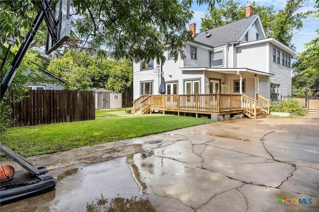 610 N 7th St, Temple, TX 76501 - rear view of property featuring french doors, a storage shed, a chimney, a deck, and a patio