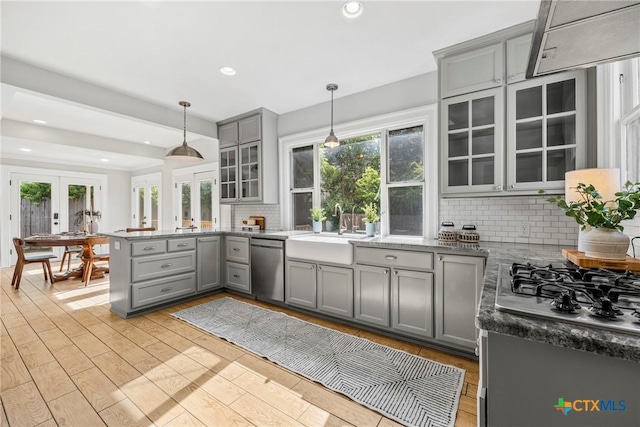 610 N 7th St, Temple, TX 76501 - kitchen with gray cabinetry, stainless steel appliances, french doors, a peninsula, and decorative backsplash