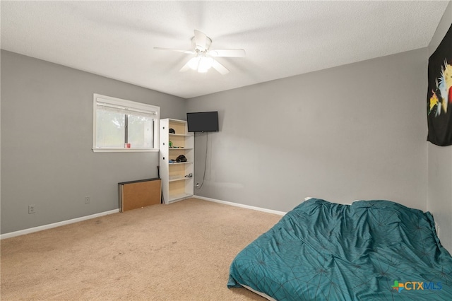 402 Teakwood Dr, Victoria, TX 77901 - bedroom with carpet floors, baseboards, ceiling fan, and a textured ceiling