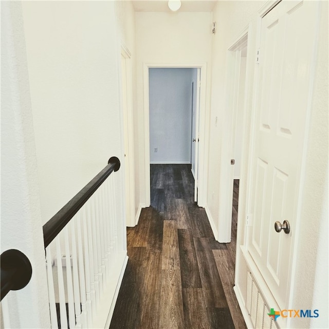 hallway with dark wood-type flooring