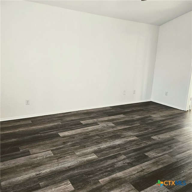 unfurnished room with dark hardwood / wood-style floors