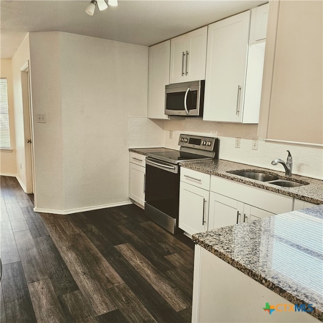 kitchen featuring white cabinetry, appliances with stainless steel finishes, dark hardwood / wood-style floors, and sink