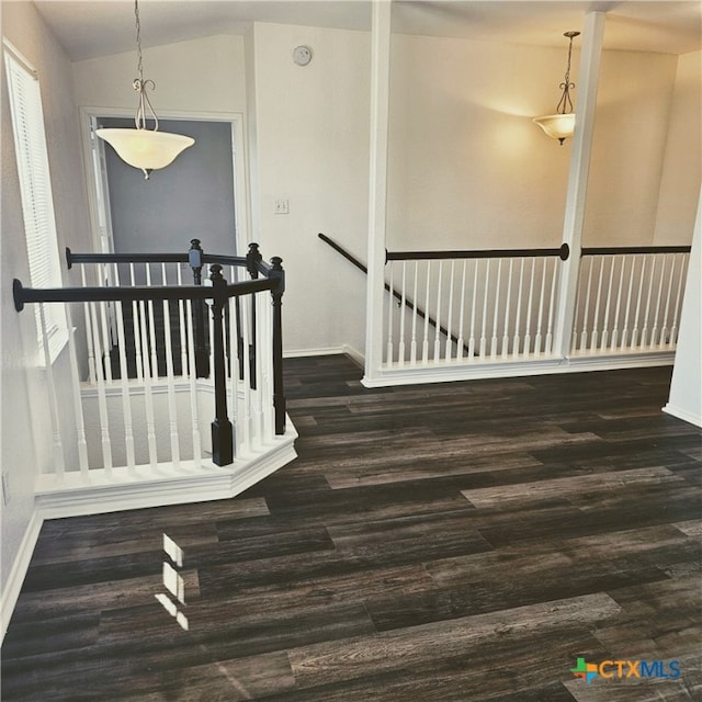 stairway featuring wood-type flooring and vaulted ceiling