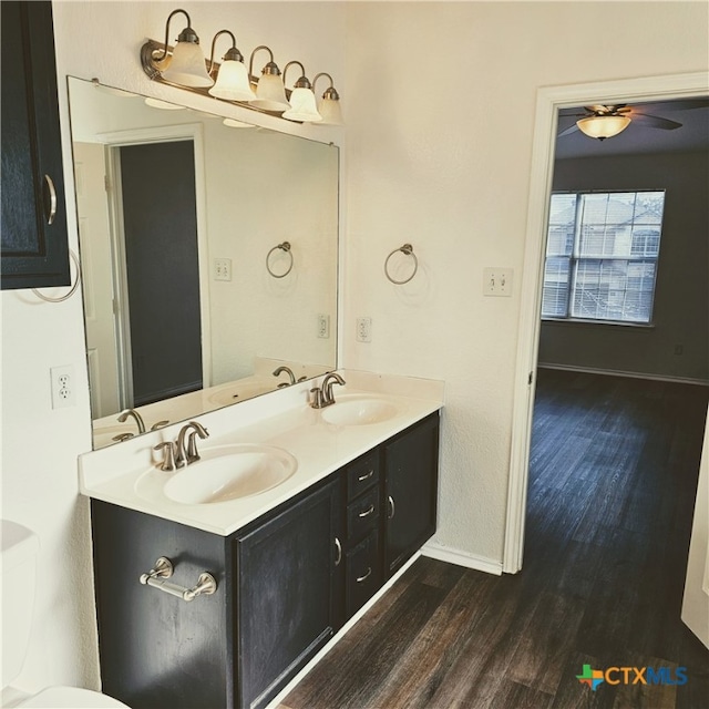 bathroom with ceiling fan, wood-type flooring, and vanity