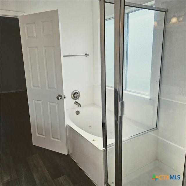 bathroom with hardwood / wood-style floors and separate shower and tub