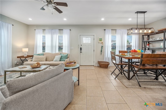 living room featuring a healthy amount of sunlight, ceiling fan, and light tile patterned flooring