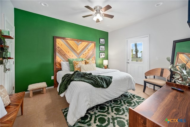 bedroom with ceiling fan and light tile patterned floors