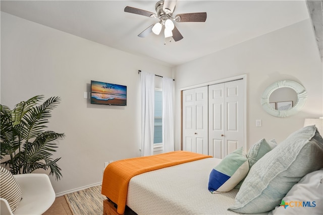 bedroom featuring a closet, hardwood / wood-style flooring, and ceiling fan