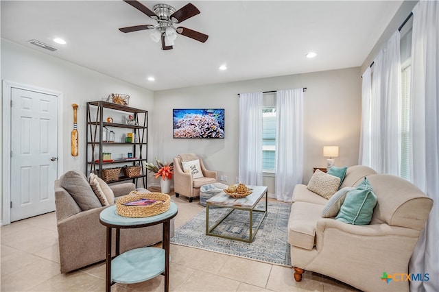 living room featuring light tile patterned floors and ceiling fan