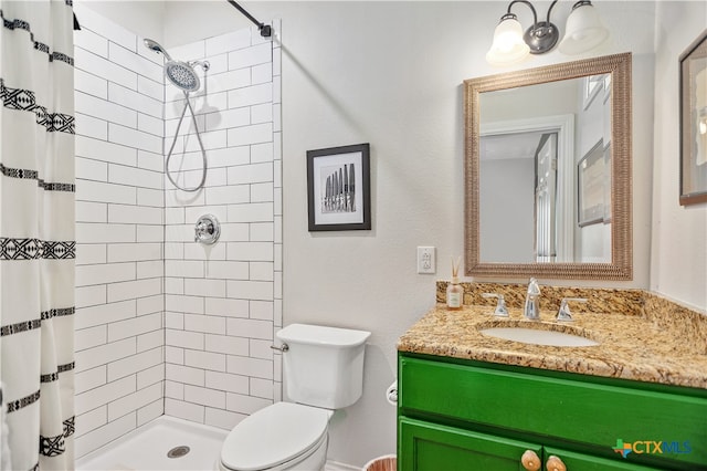 bathroom with walk in shower, vanity, and toilet