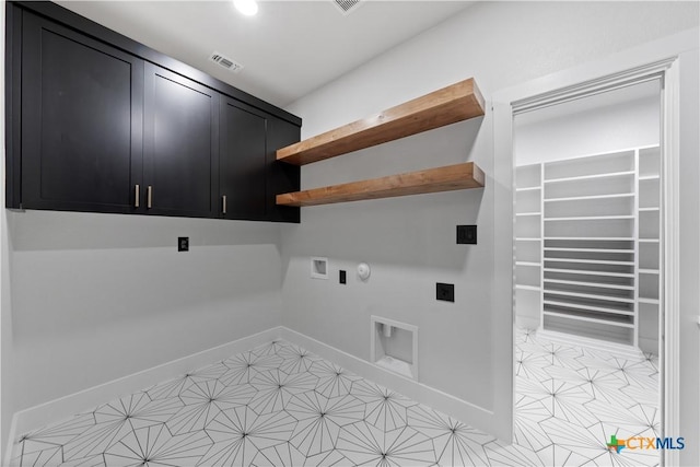 laundry room with cabinet space, hookup for a washing machine, gas dryer hookup, baseboards, and hookup for an electric dryer