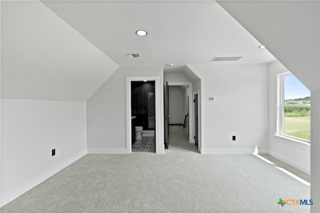 bonus room featuring visible vents, carpet flooring, baseboards, and lofted ceiling