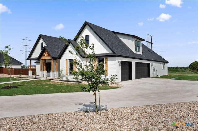 modern inspired farmhouse featuring fence, an attached garage, brick siding, a front yard, and concrete driveway