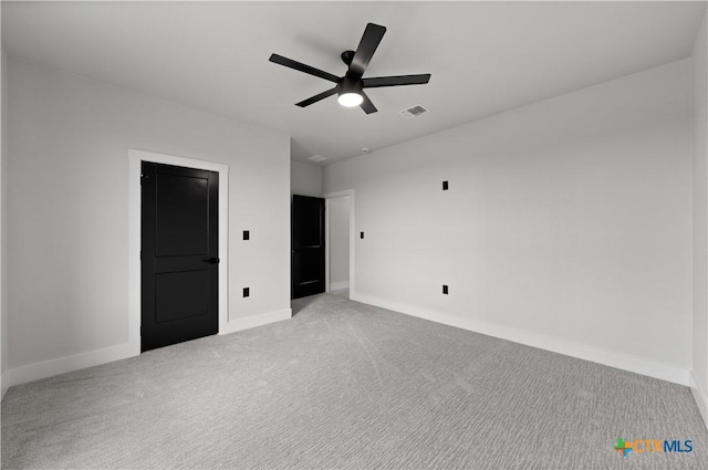 unfurnished bedroom featuring a ceiling fan, baseboards, visible vents, and light carpet