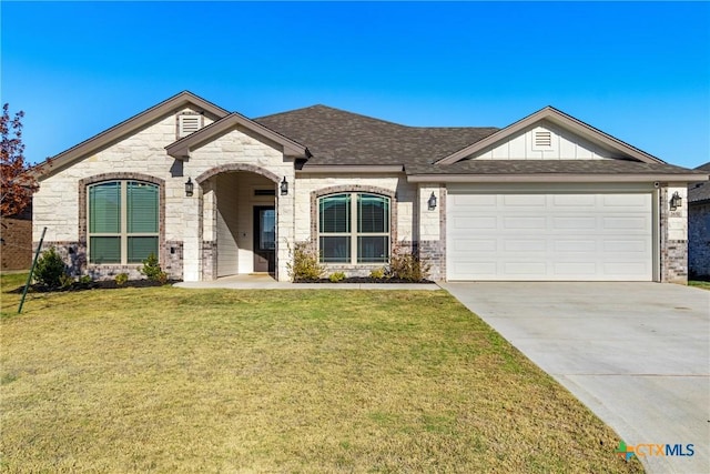 view of front of property featuring a front yard and a garage