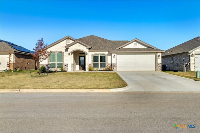 view of front of property featuring a front yard and a garage