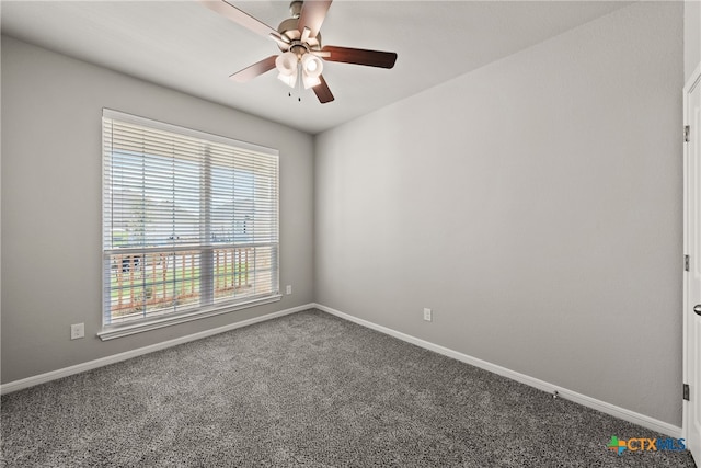 carpeted spare room featuring ceiling fan