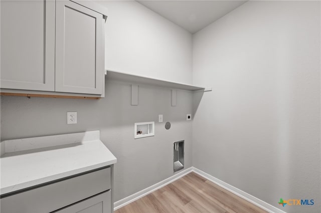 laundry area with light hardwood / wood-style flooring, electric dryer hookup, cabinets, and washer hookup