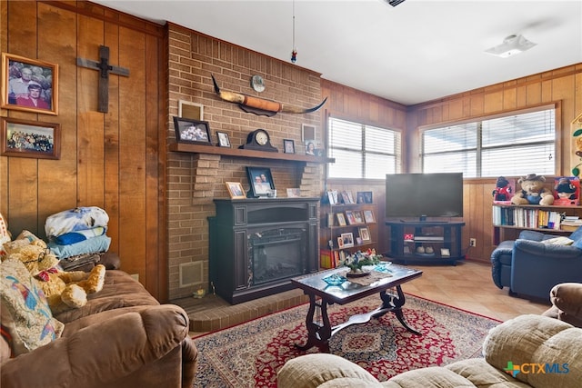 living room featuring light tile patterned floors, a fireplace, and wood walls