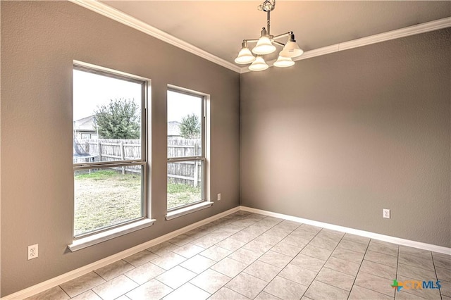 tiled spare room with a healthy amount of sunlight, ornamental molding, and a chandelier