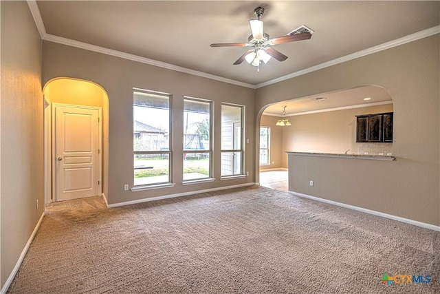 unfurnished living room featuring light carpet, ceiling fan with notable chandelier, and ornamental molding