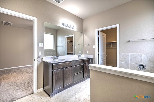 bathroom with tile patterned floors and vanity