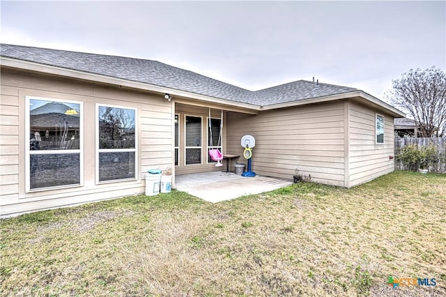 back of property featuring a yard and a patio