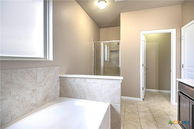 bathroom with tile patterned flooring, vanity, and separate shower and tub